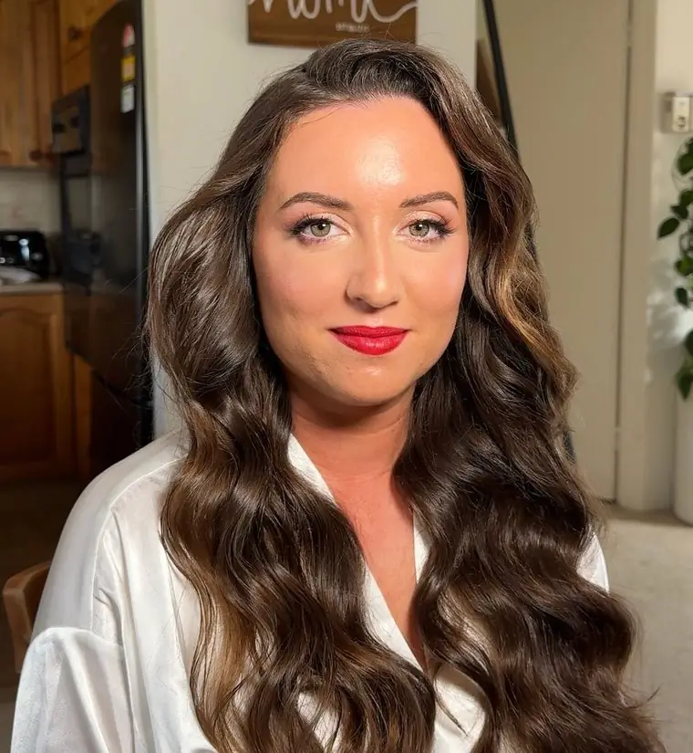 A race-day look: a red lip and long glossy waves