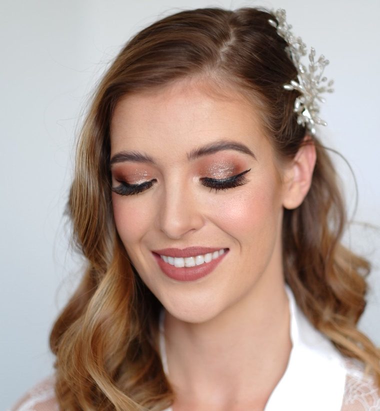 Bridal glam: a rose-gold shimmer eye, a soft pink lip, loose waves and a crystal hair comb